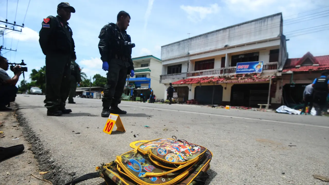Tas sekolah tergeletak di lokasi serangan bom di luar sebuah sekolah di distrik Tak Bai, Thailand, Selasa (6/9). Bom motor itu meledak ketika seorang ayah mengantarkan putrinya (4) ke sekolah hingga menyebabkan keduanya tewas.